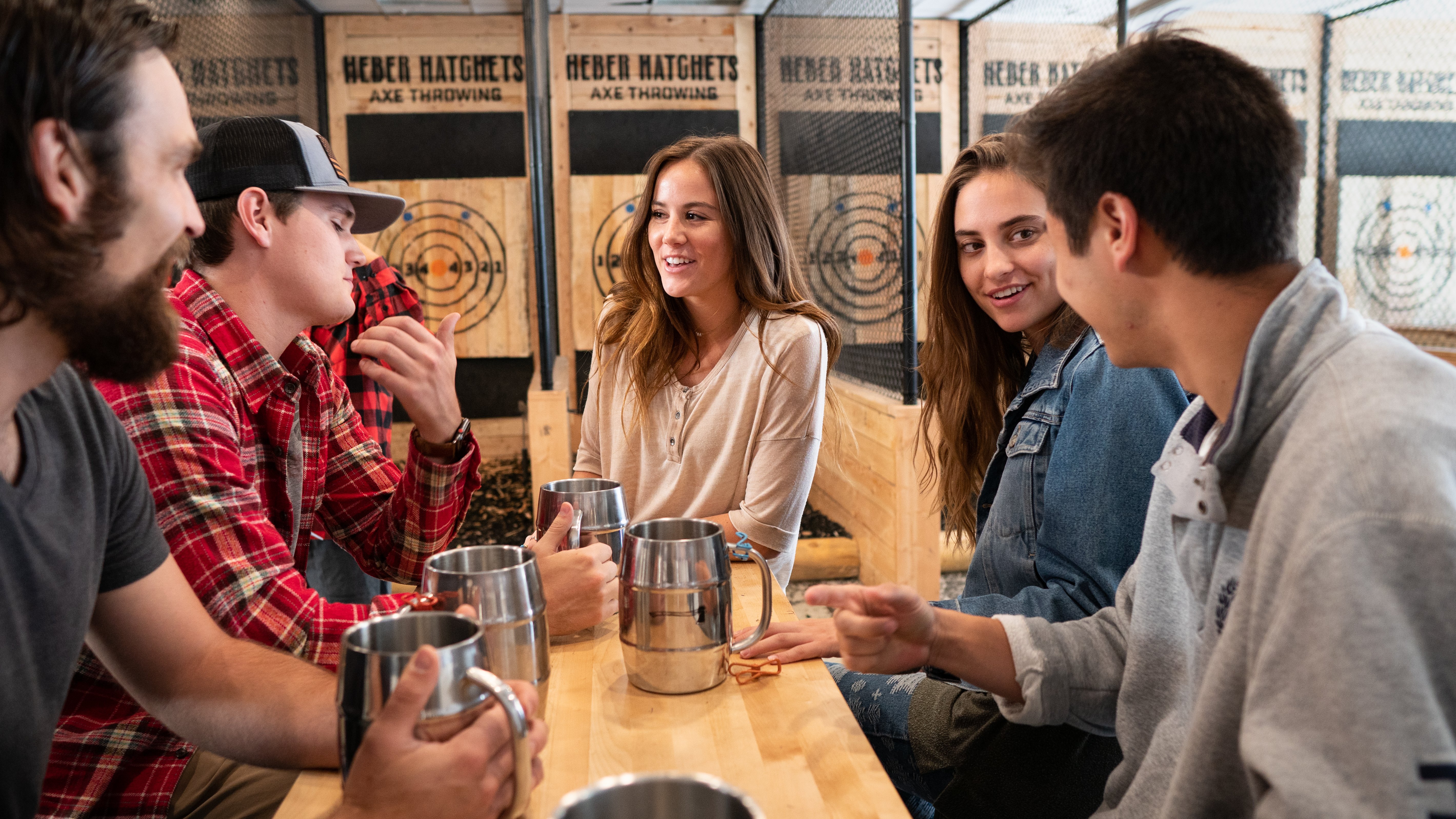 Couples on a group date talk together at Heber Hatchets in Provo